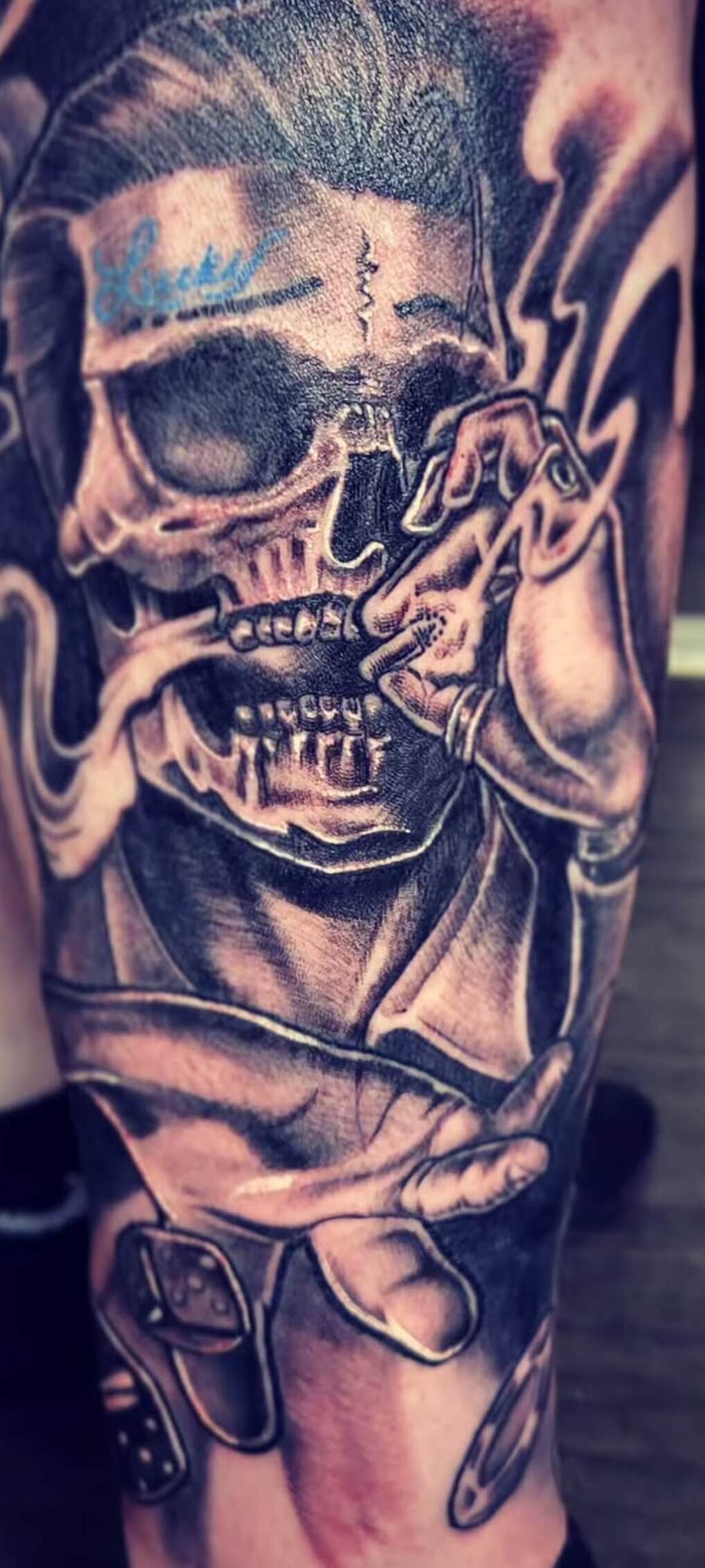 Black and grey realism tattoo of a smoking skull wearing sunglasses, with stylized smoke and dice details, inked at Old Stone Tattoo House in Athlone, Ireland